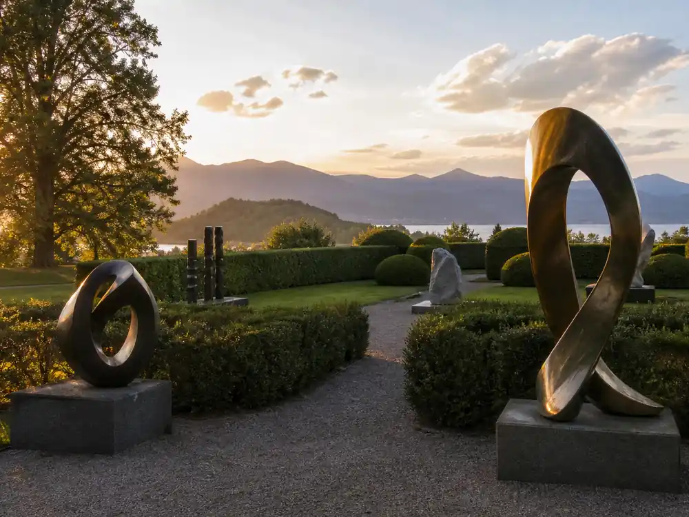 Outdoor sculpture garden at golden hour, an illiquid asset context for Brad Pitt net worth 2026