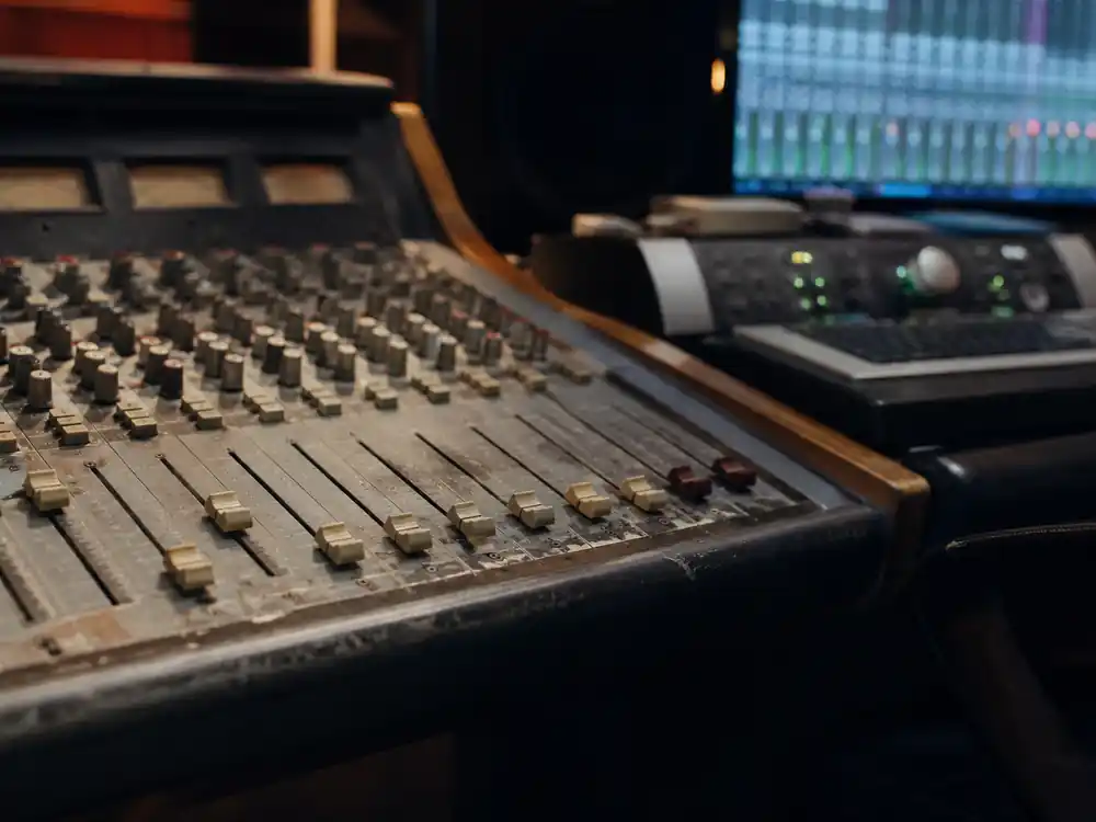 Worn analog mixing console beside modern gear for Bruno Mars net worth over the years timeline