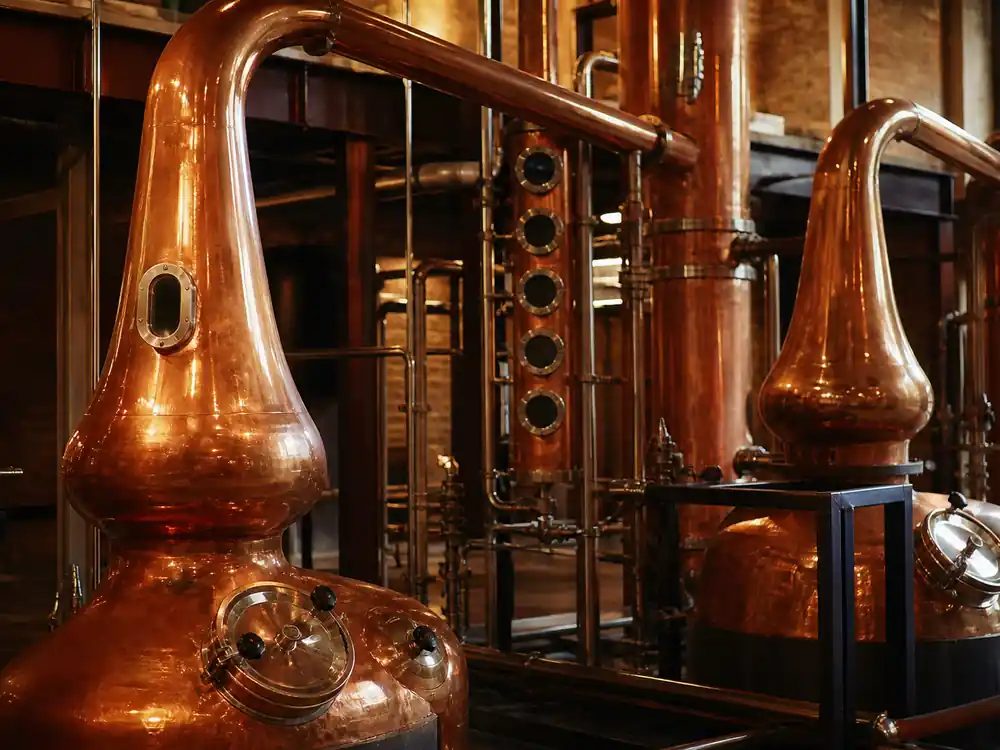 Copper distillery stills representing Dwayne Johnson net worth 2026 Teremana equity mark