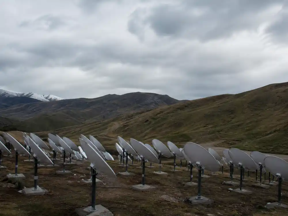 Field of satellite dish antennas linked to Elon Musk net worth 2026 broadband infrastructure holdings
