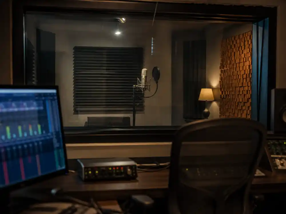 Vocal booth through control-room glass for Eminem net worth 2026 held catalog