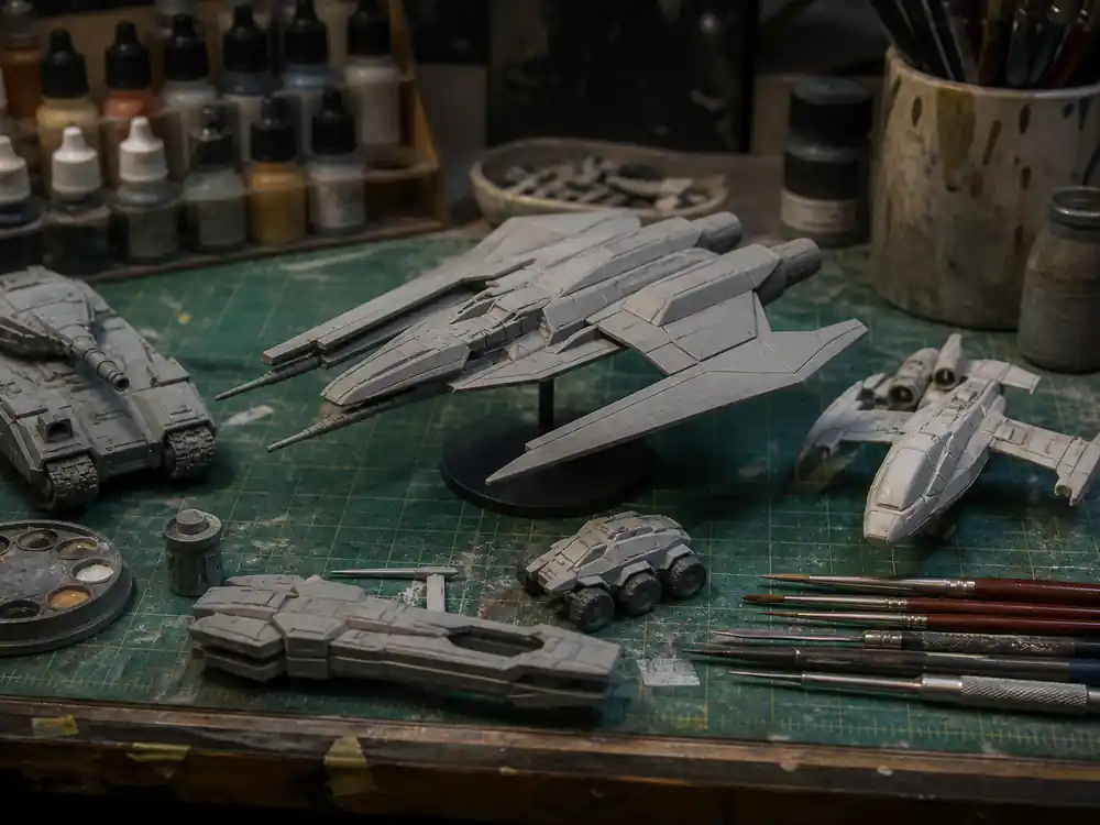Unmarked sci-fi miniatures on model-shop bench showing George Lucas net worth 2026 from industrial effects heritage