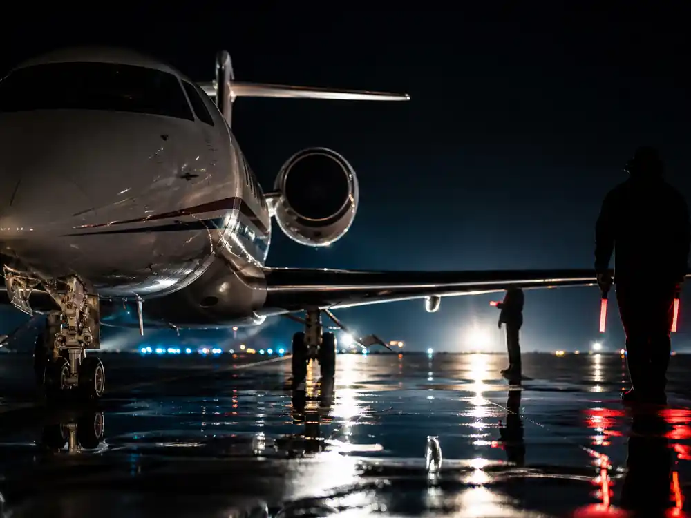 Private jet on wet tarmac at night, an asset-conversion setting in how Angelina Jolie makes money