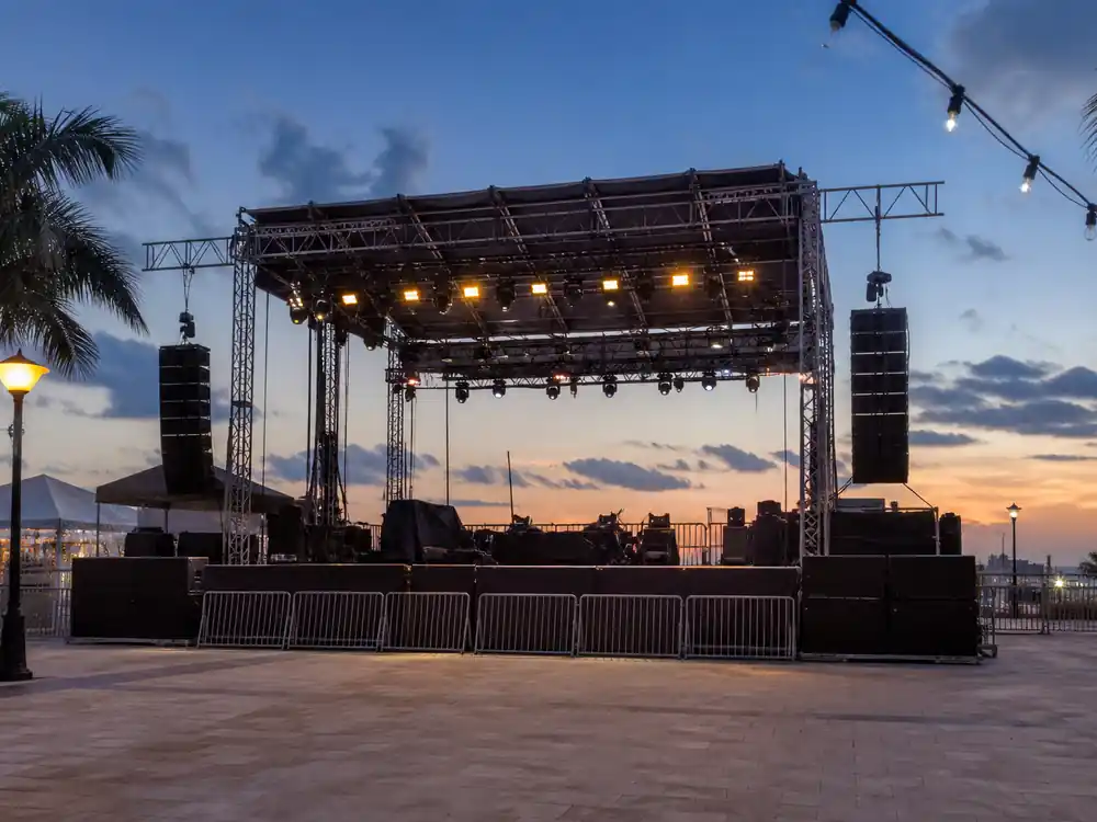 Outdoor plaza concert stage at dusk tied to how Bad Bunny makes money from Puerto Rico residencies