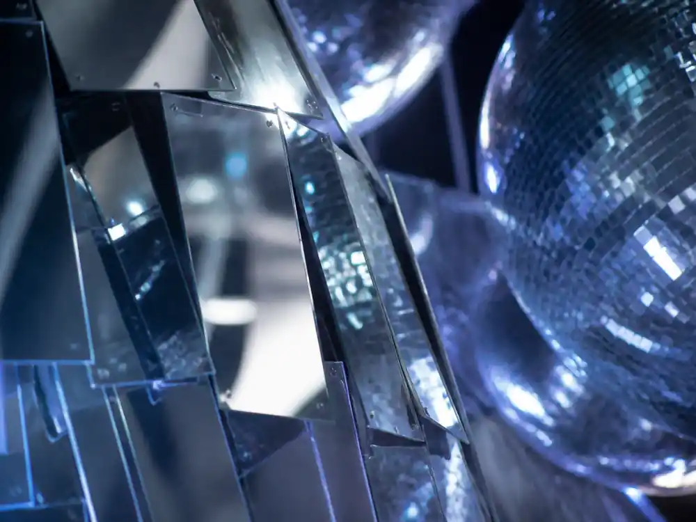 Silver chrome mirror panels on a concert stage tied to how much is Beyonce worth versus Taylor Swift
