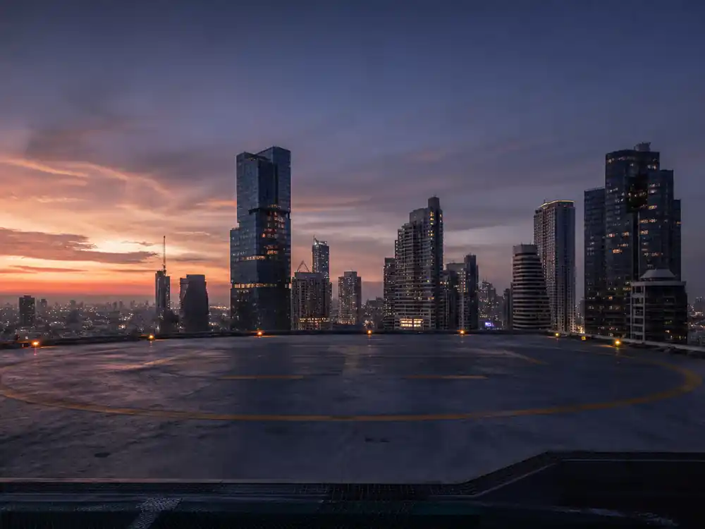 Empty high-rise helipad at dusk framing how much is Dwayne Johnson worth versus Forbes billionaire performers